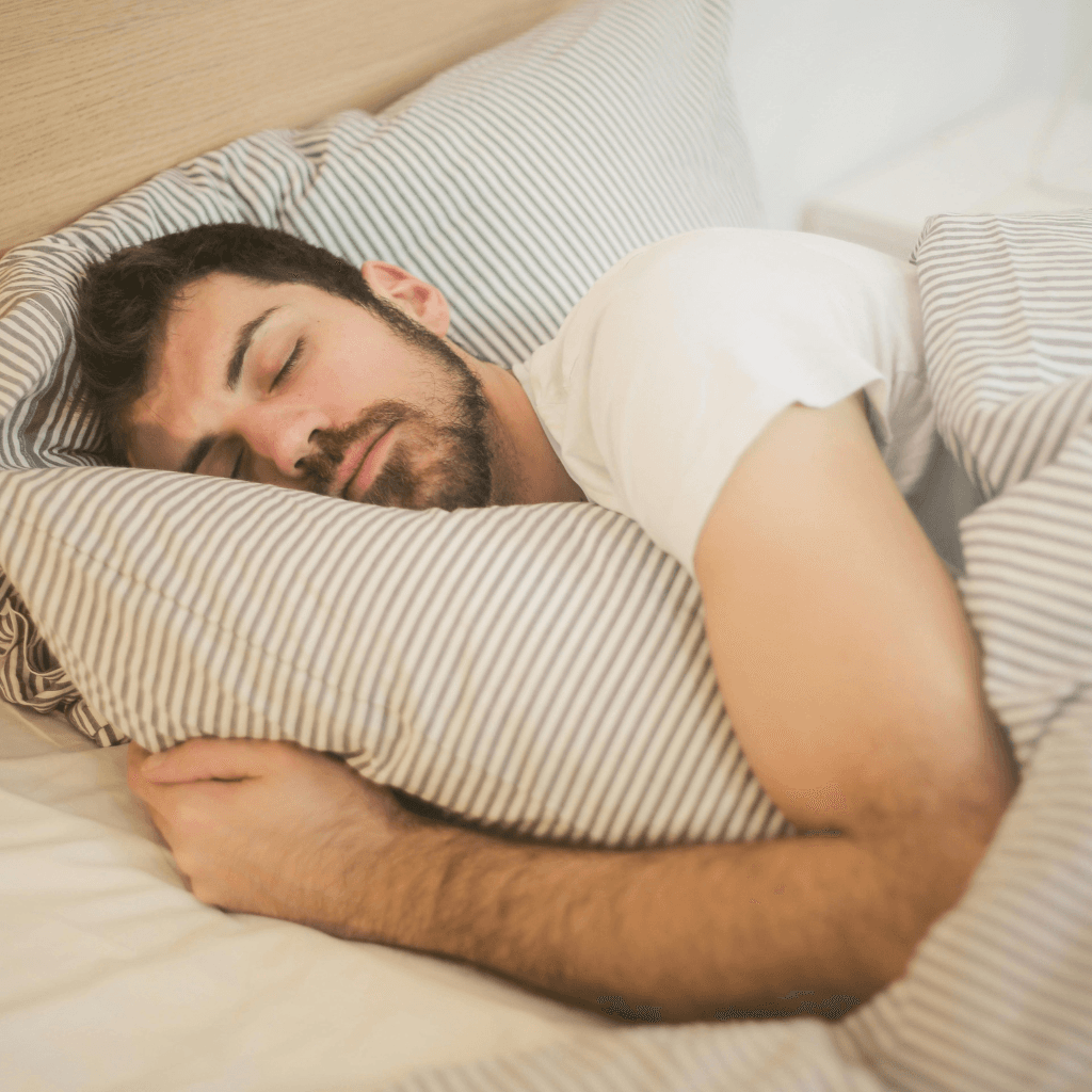 Person sleeping peacefully, representing a calmer state after consistent CBT journaling.